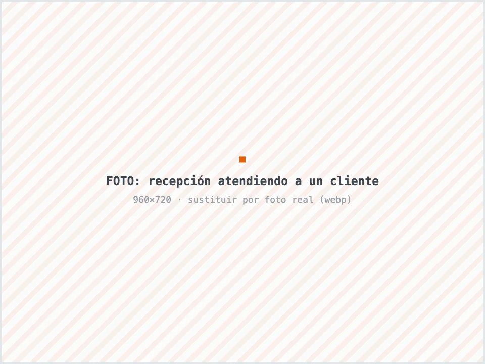 Recepcionista de taller mecánico explicando un presupuesto a un cliente en el mostrador